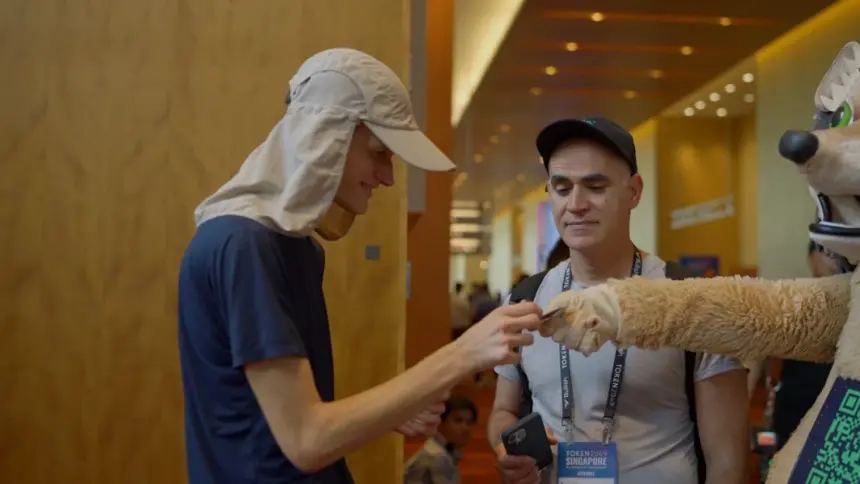 Vitalik Buterin receives a branded condom from the GraphDex hedgehog mascot at Token2049 Singapore, September 2024. Video shows Buterin bowing to the hedgehog immediately after.