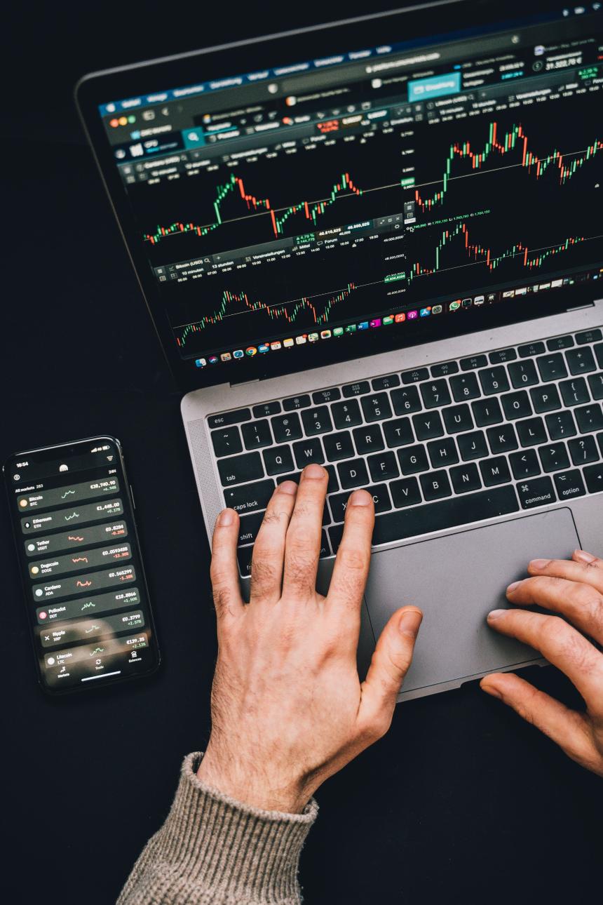 Analyst reviewing cryptocurrency market data on multiple screens