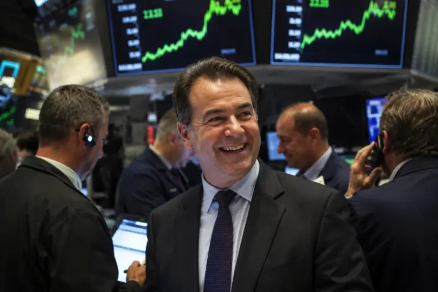 Crypto traders on a busy exchange floor with rising market charts overhead.